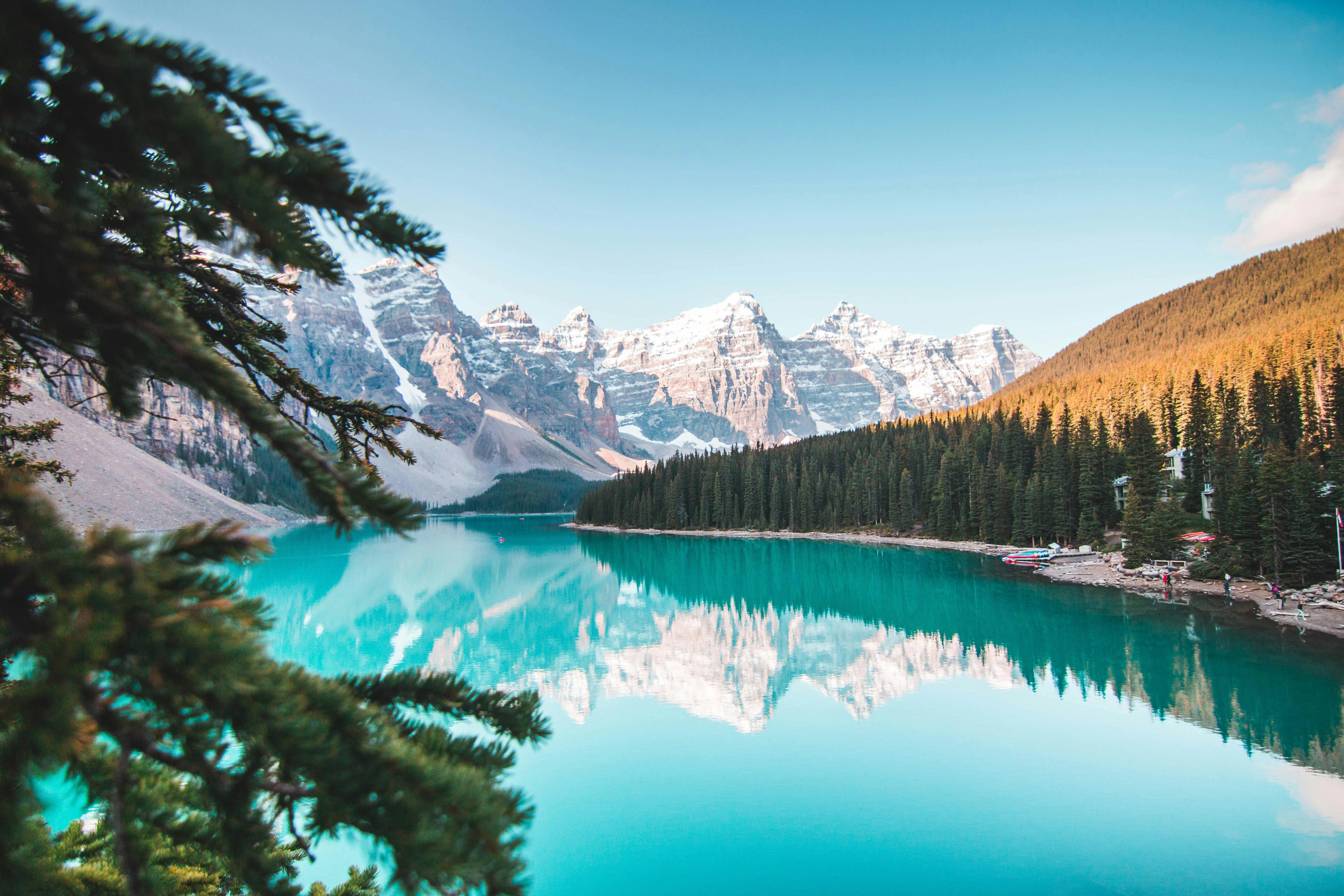 A striking view of Moraine Lake’s vivid blue waters framed by rugged mountain peaks and evergreen forests