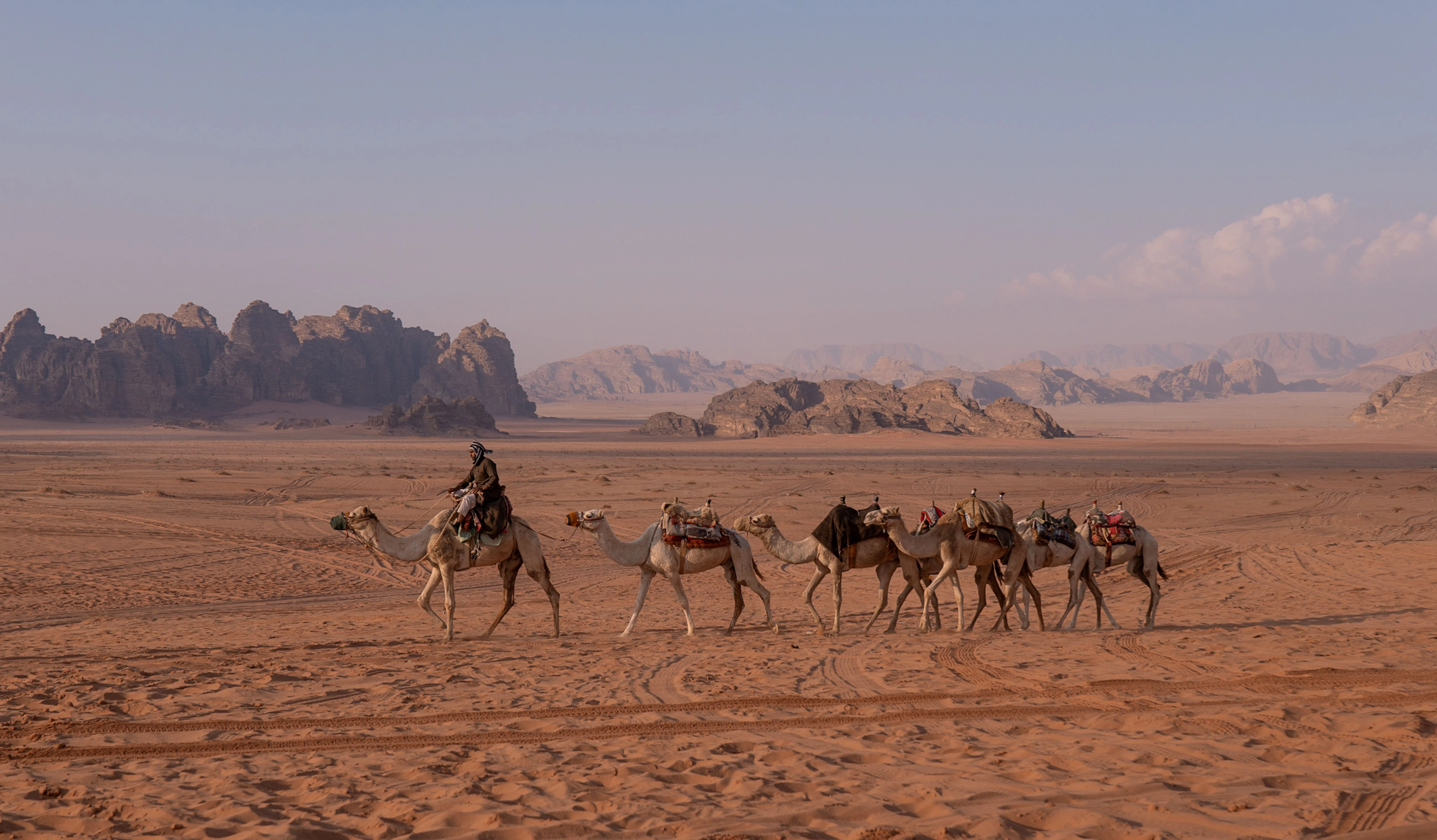People riding camels in Wadi Rum, Jordan
