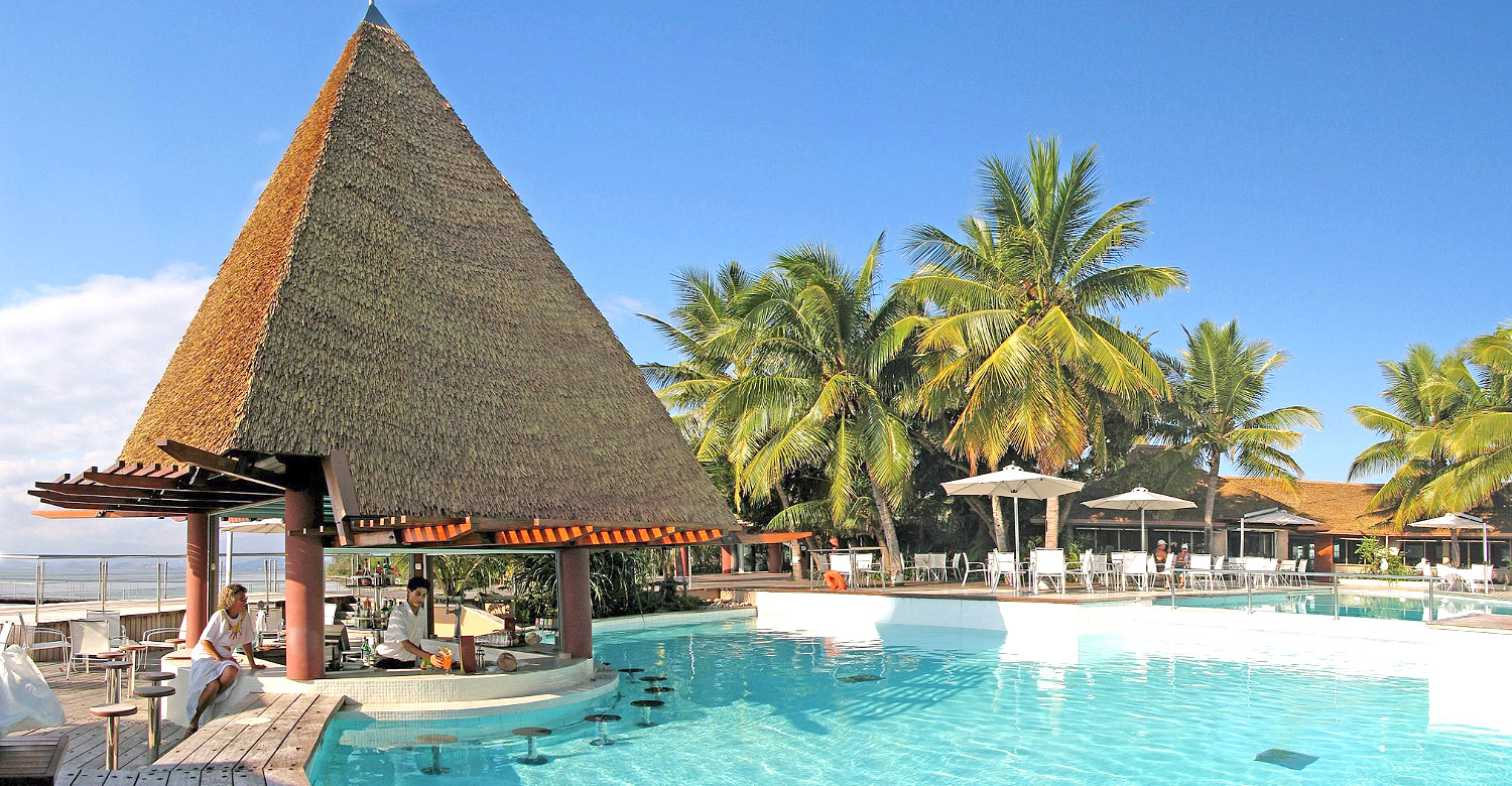 Unwind and mingle at Escapade Island's idyllic pool and bar.