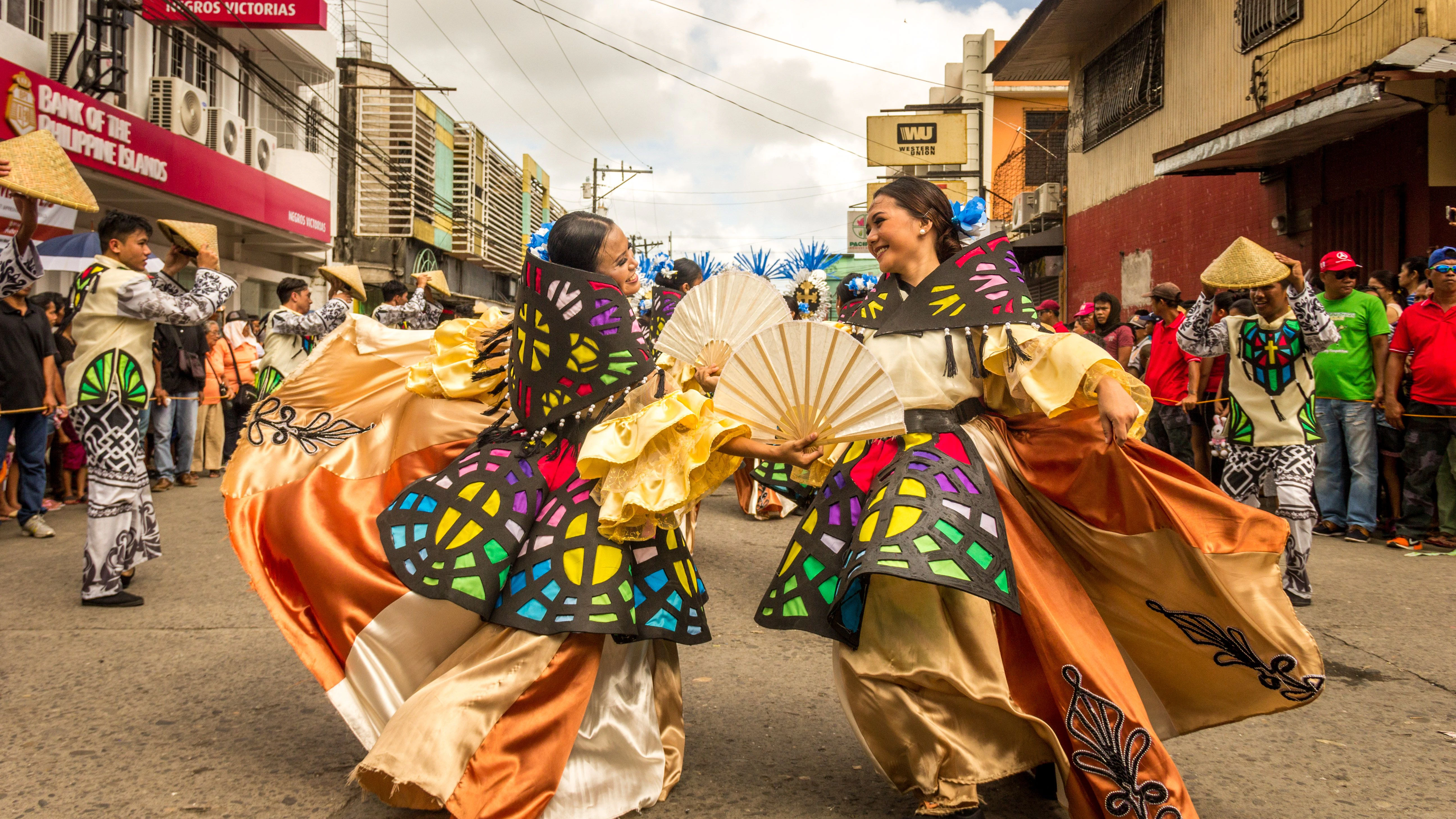 Traditional Philippine cultural festival featuring performers in colourful attire celebrating local heritage and community traditions