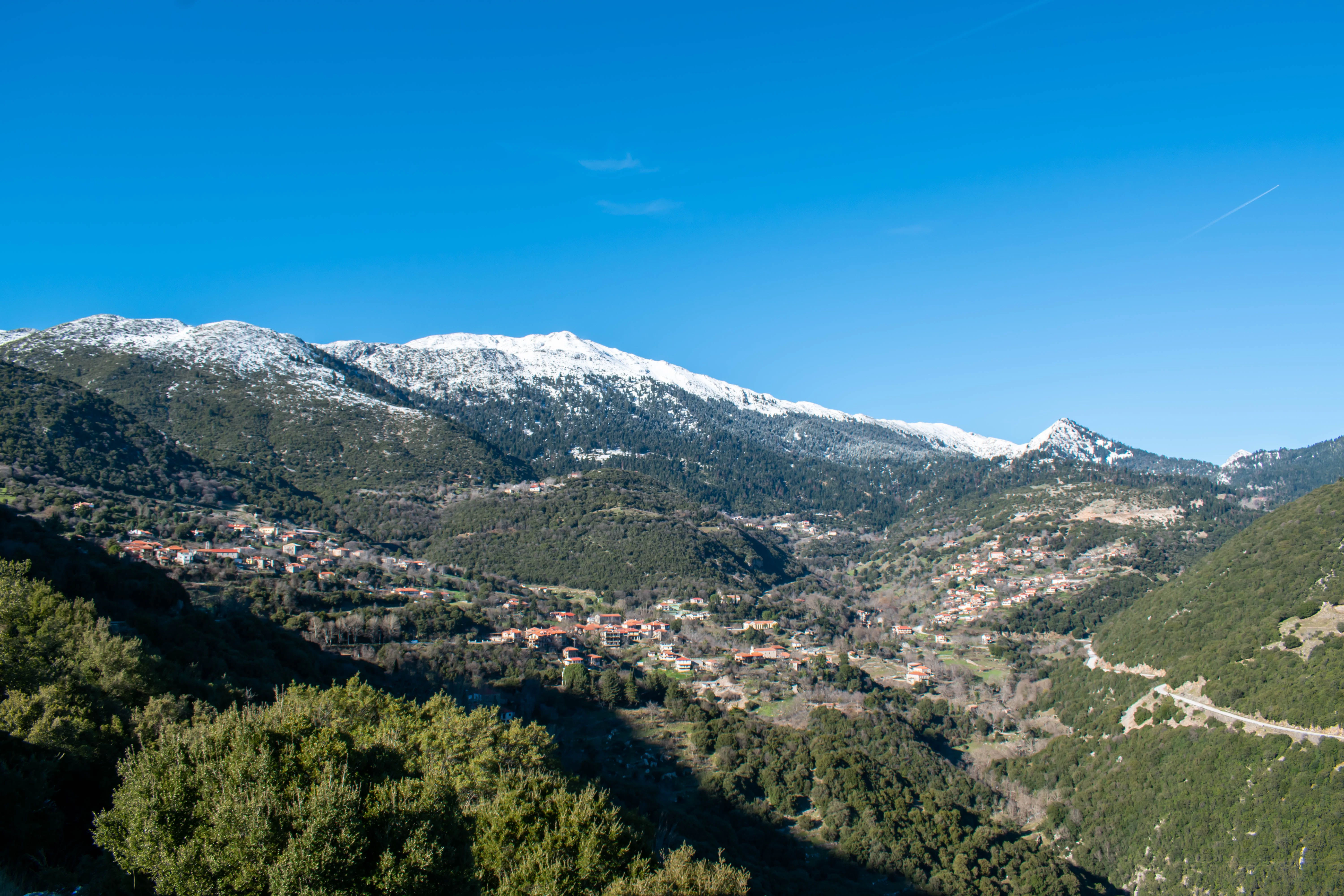 Snow-capped mountains overlooking the rugged landscapes of inland Greece's mountainous regions