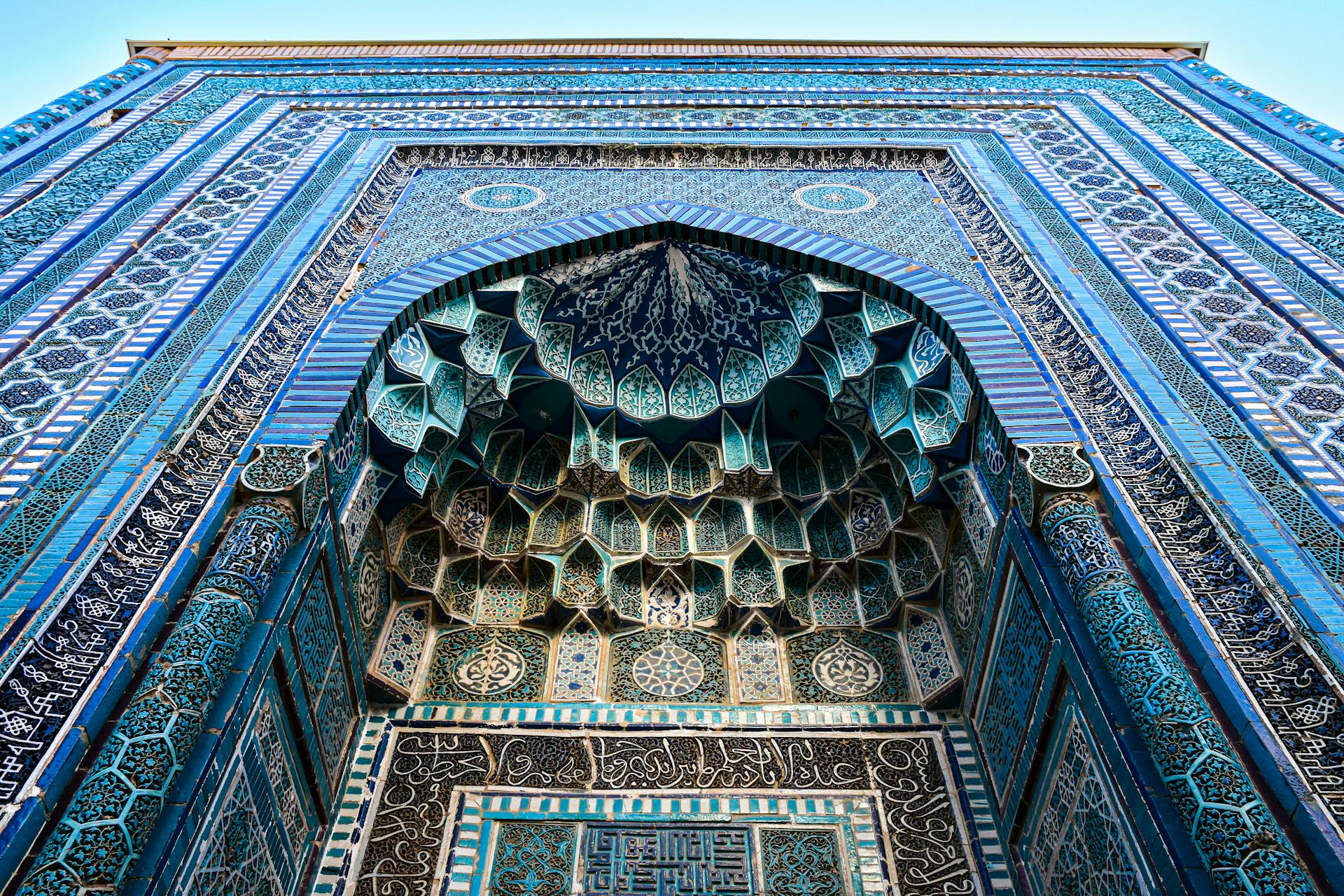 A close-up shot of the ornate, vibrant patterns on the Shah-i-Zinda Necropolis in the old city of Samarkand in Uzbekistan.