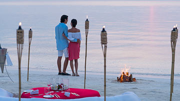 Couple enjoying bespoke dining experience at Anantara Dhigu Maldives