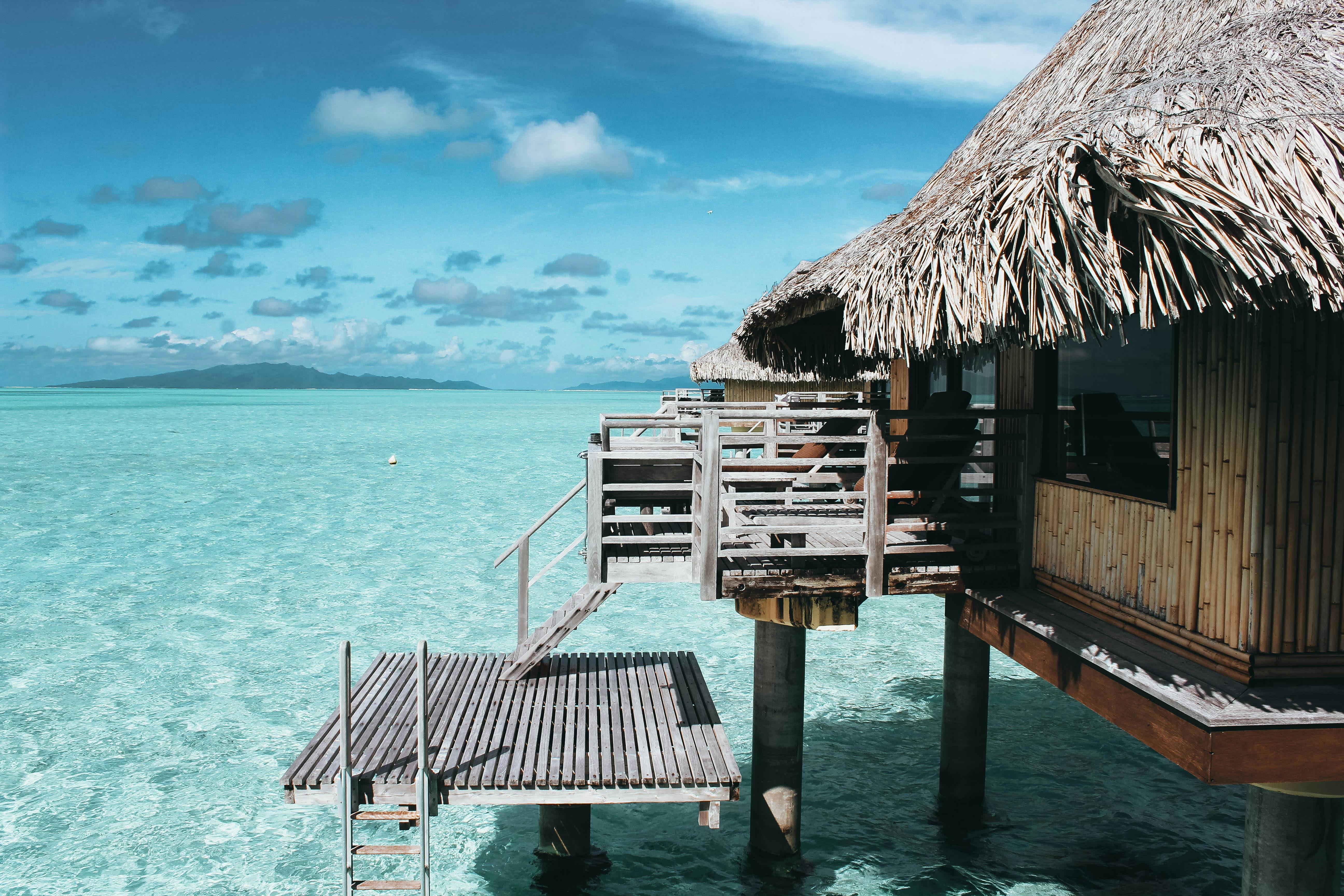 Brown nipa hut on a body of water