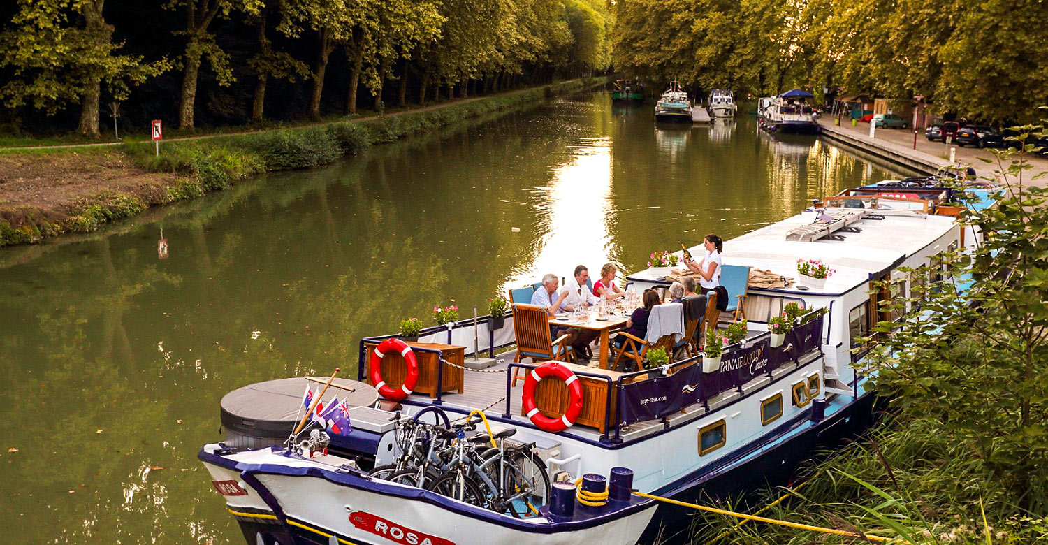 Guests of Rosa barge dine on deck.