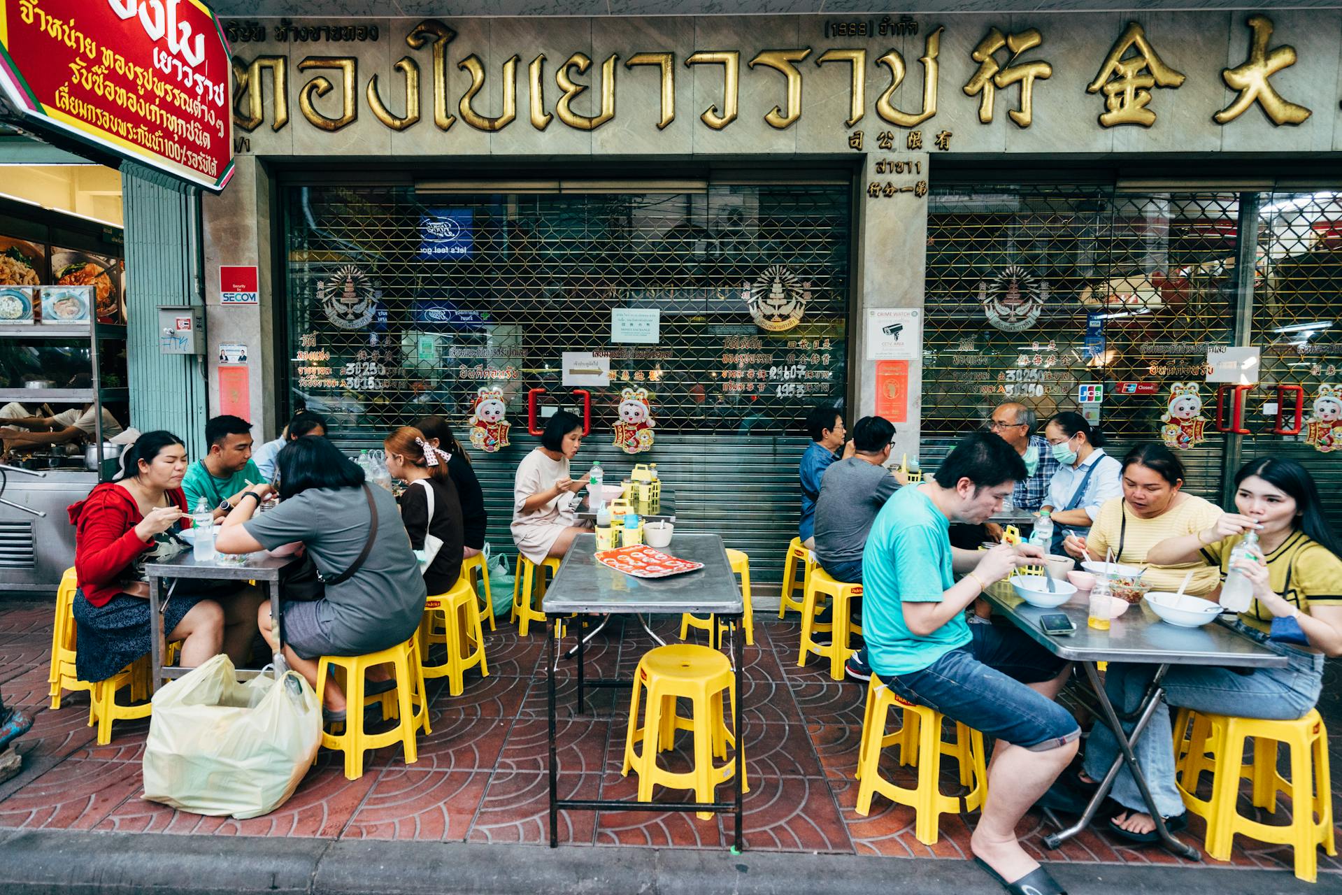 People eating street food in Thai restaurant